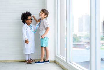 The child wears a doctor's uniform and uses a stethoscope to check the general disease.