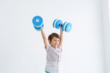 kid looks healthy, lifting weights, dumbbells, strengthening your bones and growing your child.