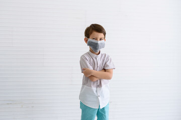 Boy wearing a mask To prevent viruses and dust germs looking at the camera