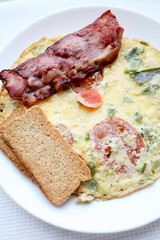 Omelet with smoked bacon slices