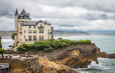 Fototapeta na wymiar Biarritz, France - August 11 2019: Castle-like manor house on the coast facing the rough sea