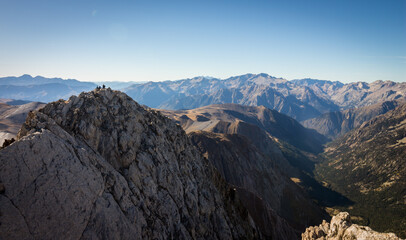 Climbers at the top of a mountain in the Pyrenees on a sunny summer day