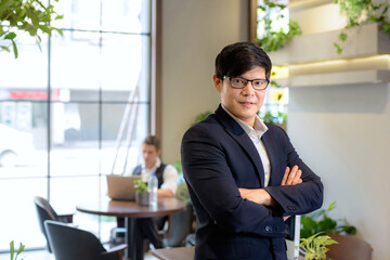 A business man looking straight into the back camera sitting at work