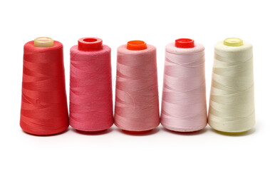 spools of thread for the textile industry on white background