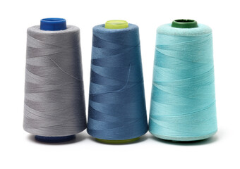 spools of thread for the textile industry on white background
