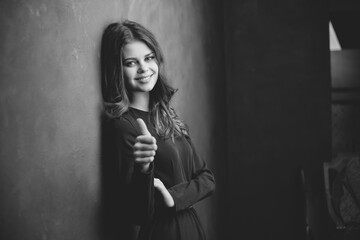 portrait of emotional woman indoors near wall cropped view