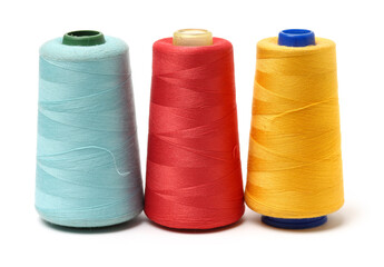 spools of thread for the textile industry on white background