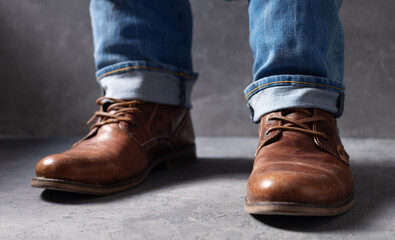 men's legs in jeans and old travel vintage leather boots