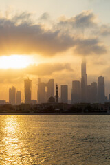 Fototapeta na wymiar Dubai, UAE - 03.06.2021 Dubai public beach with city skyline on background.Sunrise hour. Outdoor