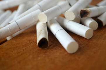 A pack of cigarettes. Cigarette butts. Smoking.