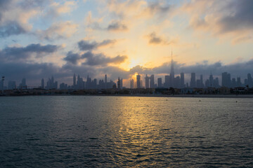Fototapeta premium Dubai, UAE - 03.06.2021 Dubai public beach with city skyline on background.Sunrise hour. Outdoor