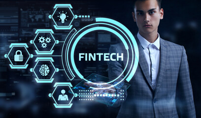 Fintech -financial technology concept.Young businessman  select the icon Fintech on the virtual display.