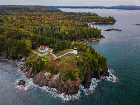 Owls Head Lighthouse  on the Rocky cliffs on the Maine Coast in Autumn from an aerial drone image