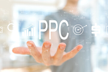 PPC - Pay per click concept with young man holding his hand