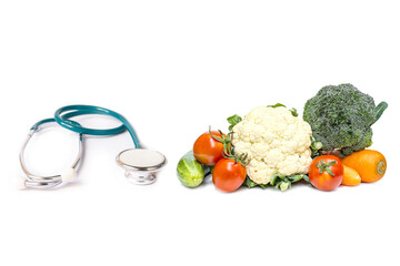 fresh vegetable  with green stethoscope on white background.