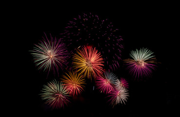 Fireworks with different color and pattern for celebration in various event including new year, party, ceremony, birthday or other show and display on night dark sky background.