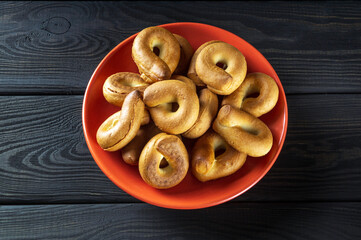 Homemade round bagels in an orange plate. Idea for a delicious breakfast or dinner. Top view