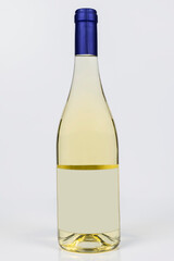 Beautiful burgundy bottle of white wine on white surface and background