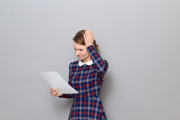 Portrait of disappointed young woman reading document