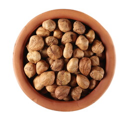 Whole hazelnuts in clay pot isolated on white background, top view
