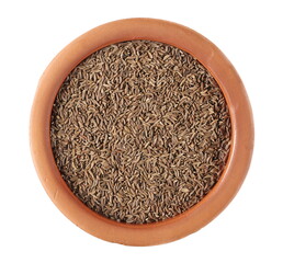 Pile of cumin seeds in clay pot isolated on white background, top view