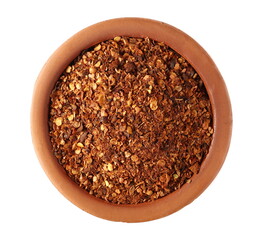Spicy chili pepper flakes, crushed, milled dry red paprika pile in clay pot isolated on white background, top view