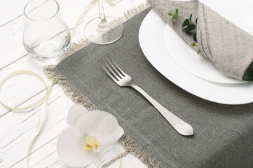 Beautiful table setting with flowers on a white wooden table, wedding table setting