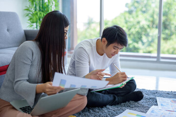 Talking to work and sitting on the floor relaxed. In his living room In his living room.