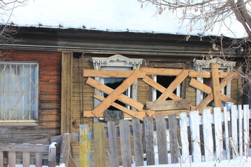 an abandoned old house with clogged windows
