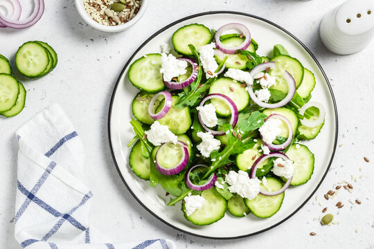 Goat cheese cucumber salad with apple cider vinegar dressing. Space for text, top view.