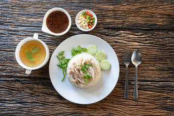 Sliced Hainan-style chicken with marinated rice and soup (Khao Mun Kai)or steamed chicken rice - Asian food style