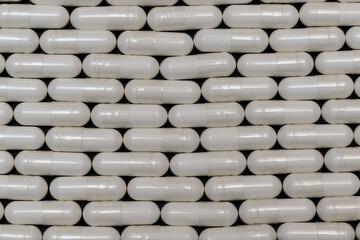 Background of medicines in the form of capsules lined in a brick style