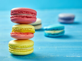 Fototapeta na wymiar Sweet Macaron of different colors on an azure background