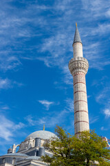 Fototapeta na wymiar Minaret and the dome of the Bayezid II Mosque against the blue sky in Istanbul, Turkey