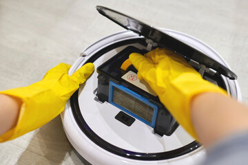 Robot vacuum cleaner, inserting filter, cleaning. Close up.