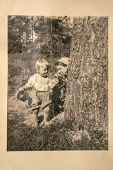 Germany - CIRCA 1930s: Mother and small kid sitting in forest. Vintage archive Art Deco era photography