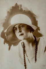 Germany - CIRCA 1920s: Portrait of female in studio. Lady with hat. Vintage Carte de Viste Art Deco era photo. Close up face