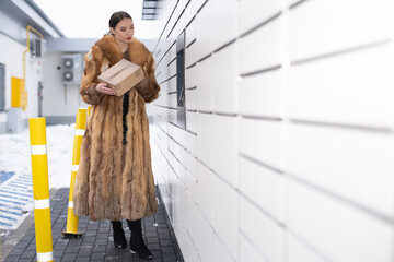 The rich woman checks the sender's address to see if she received the correct package. Receive and...