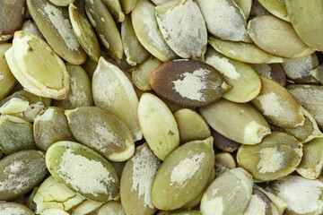Close-up background texture of green pumpkin seeds.