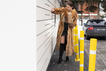 A rich woman cannot open a parcel locker box. Receive and send parcels automatically in winter.