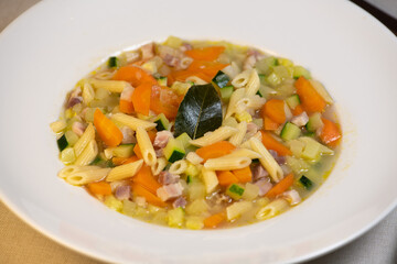 Fresh Vegetable soup and pasta in a white bowl , France