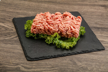 Raw pork minced meat over board