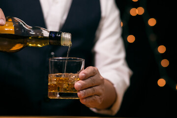 Barman pouring whiskey whiskey glass beautiful night