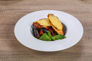 Mussels in the bowl with bread