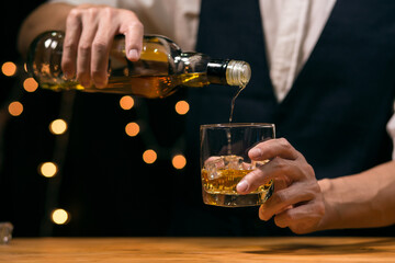 Barman pouring whiskey whiskey glass beautiful night