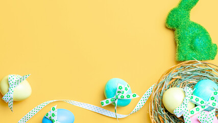 Easter banner. Colourful egg with tape ribbon on pastel yellow background in Happy Easter decoration. Foil minimalist egg design, modern top view template.