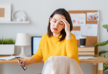 Young woman studying and having a head ache