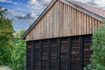 Old wooden house with weathered boards photographed in the forest