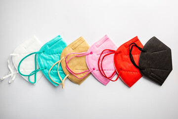 Multicolored surgical masks on white background, top view. disposable medical face masks in...