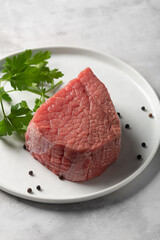 Fresh raw beef on white plate with copy space